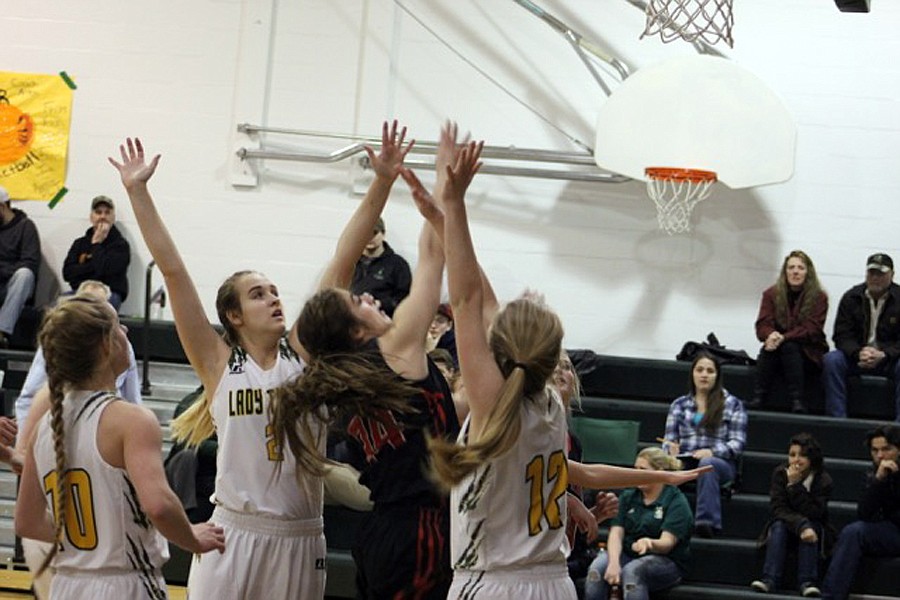 HOT SPRINGS' Karly Lawson (34) shoots over a pair of St. Regis defenders. (Kathy Woodford/Mineral Independent)