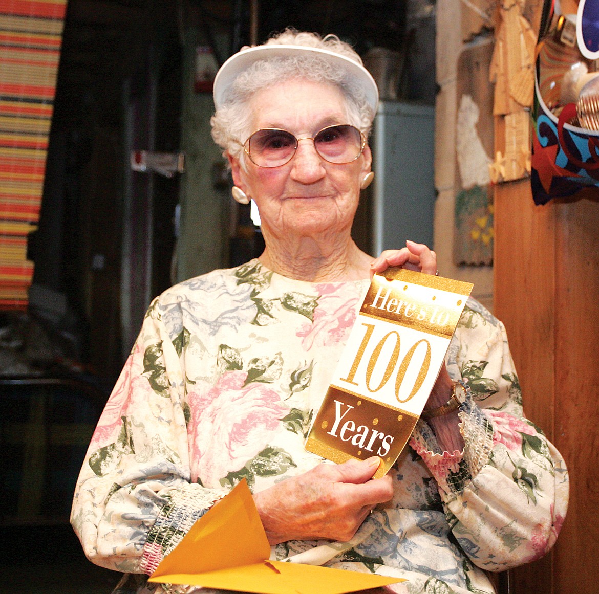 Mildred Whitehouse displays one of the many birthday cards she received during her 100th birthday party celebration Jan. 5. (Paul Sievers/TWN)