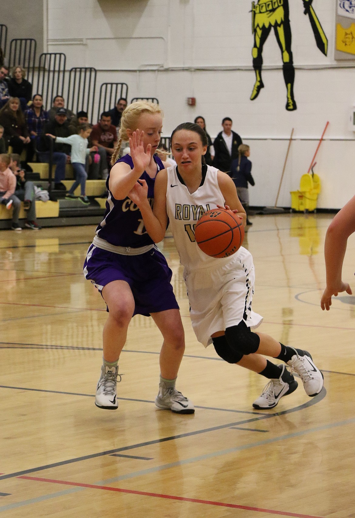 Melanie Christensen photo - Always competing Josie Phillip of Royal gets past a Connell defender and drives toward the basket last Saturday in SCAC East high school girls basketball contest. Connell won, 66-40.