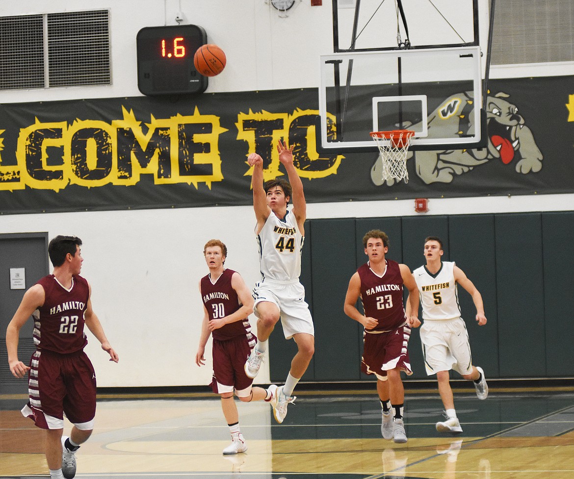 Lee Walburn launches a halfcourt shot at the halftime buzzer against Hamilton. (Daniel McKay photos / Whitefish Pilot)