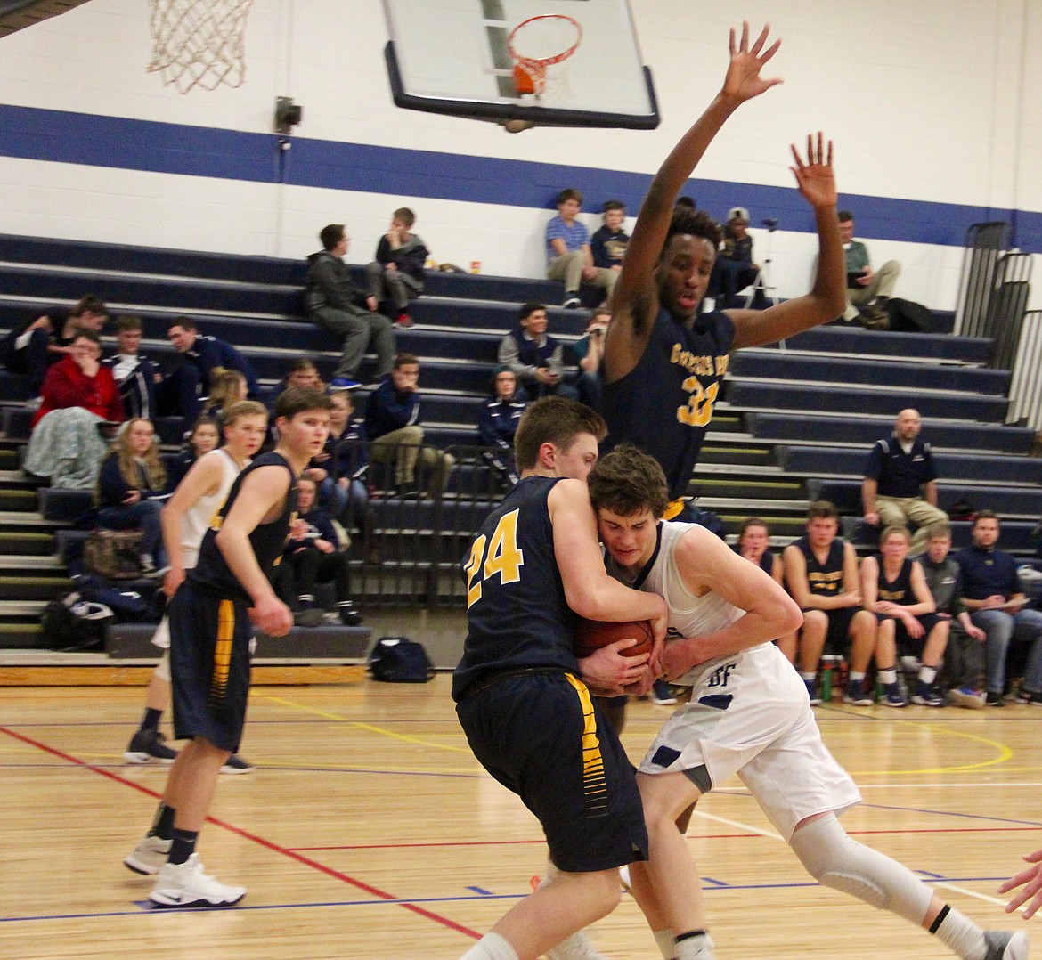 &#151;Photo by DAC COLLINS
Point guard Chris Sabin drives hard in a lane clogged with Jaguars.