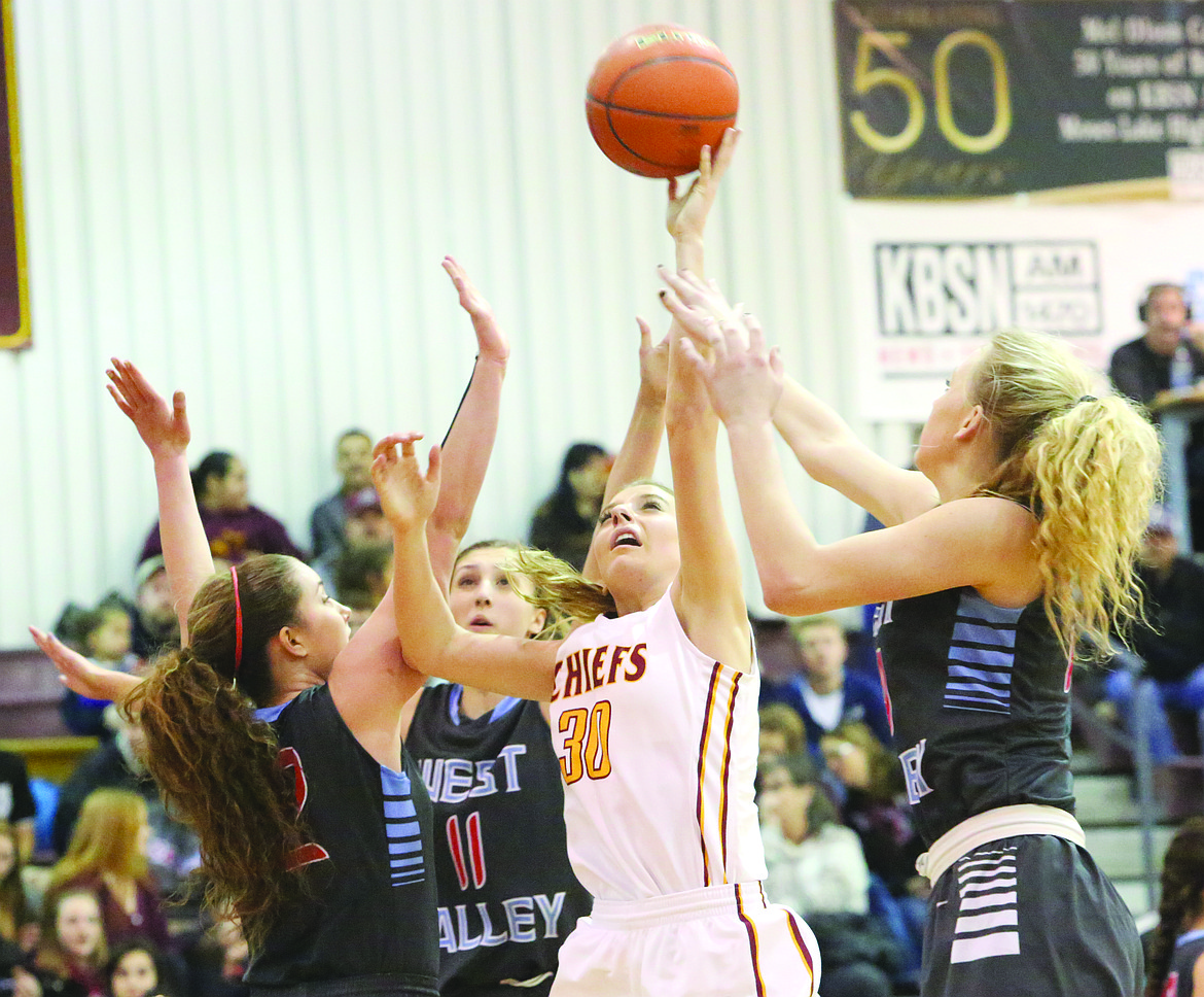 Connor Vanderweyst/Columbia Basin Herald
Jessica Olson (30) reaches for the ball between a host of West Valley defenders last season.