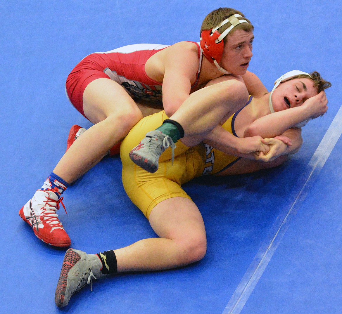 ARLEE Wrestler TJ Knoll attempts to pin Polson Pirate wrester Garrett Croft in the dual against Polson Friday afternoon at the Ronan Event&#146;s Center. (Jason Blasco/Lake County Leader)