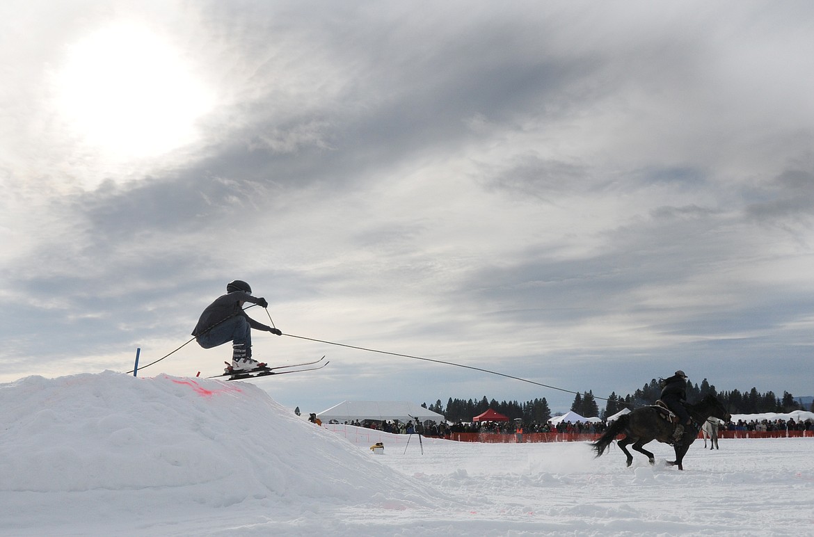 A SKIER hits the final jump as he is pulled to the finish line.