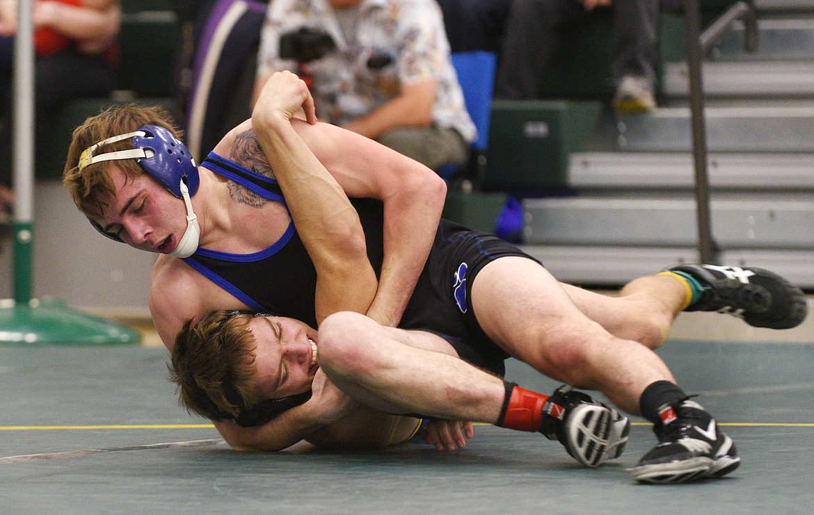 Columbia Falls 132-pounder Hunter Peterson puts Libby's Reed Christensen in a head-and-arm hold during the Whitefish Duals on Friday. (Aaric Bryan/Daily Inter Lake)