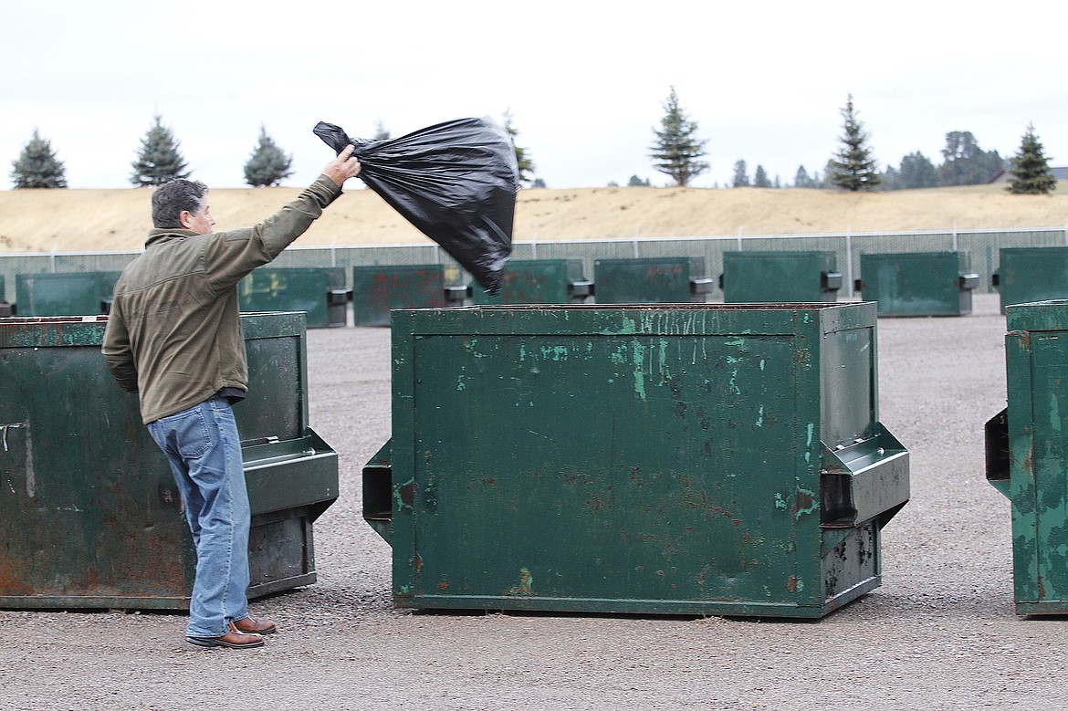 Sally Finneran/Bigfork Eagle
Gary Beaudry throws away household trash at the new green-box site.