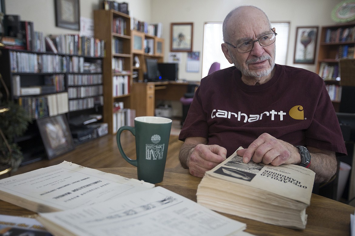 Sitting in his Coeur d&#146;Alene home, retired engineer and technical writer Vern Westgate holds the Apollo manual which he wrote, as he talks about his experience working for North American Aviation.