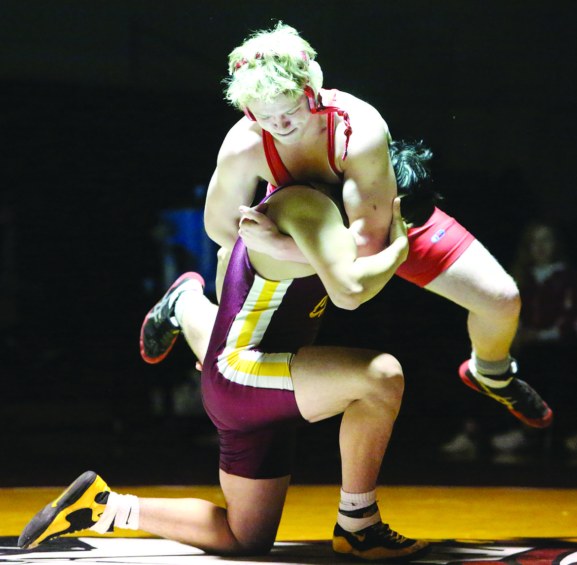 Connor Vanderweyst/Columbia Basin Herald
Bailey Sanchez (maroon) lifts Camryn Bowling into the air.