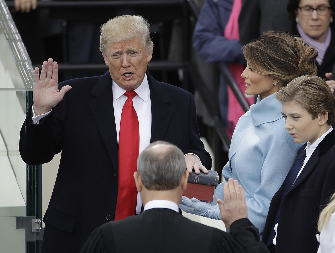 Donald Trump is sworn in as the 45th president of the United States by Chief Justice John Roberts as Melania Trump looks on during the 58th Presidential Inauguration at the U.S. Capitol in Washington, Friday, Jan. 20, 2017. (AP Photo/Matt Rourke) '