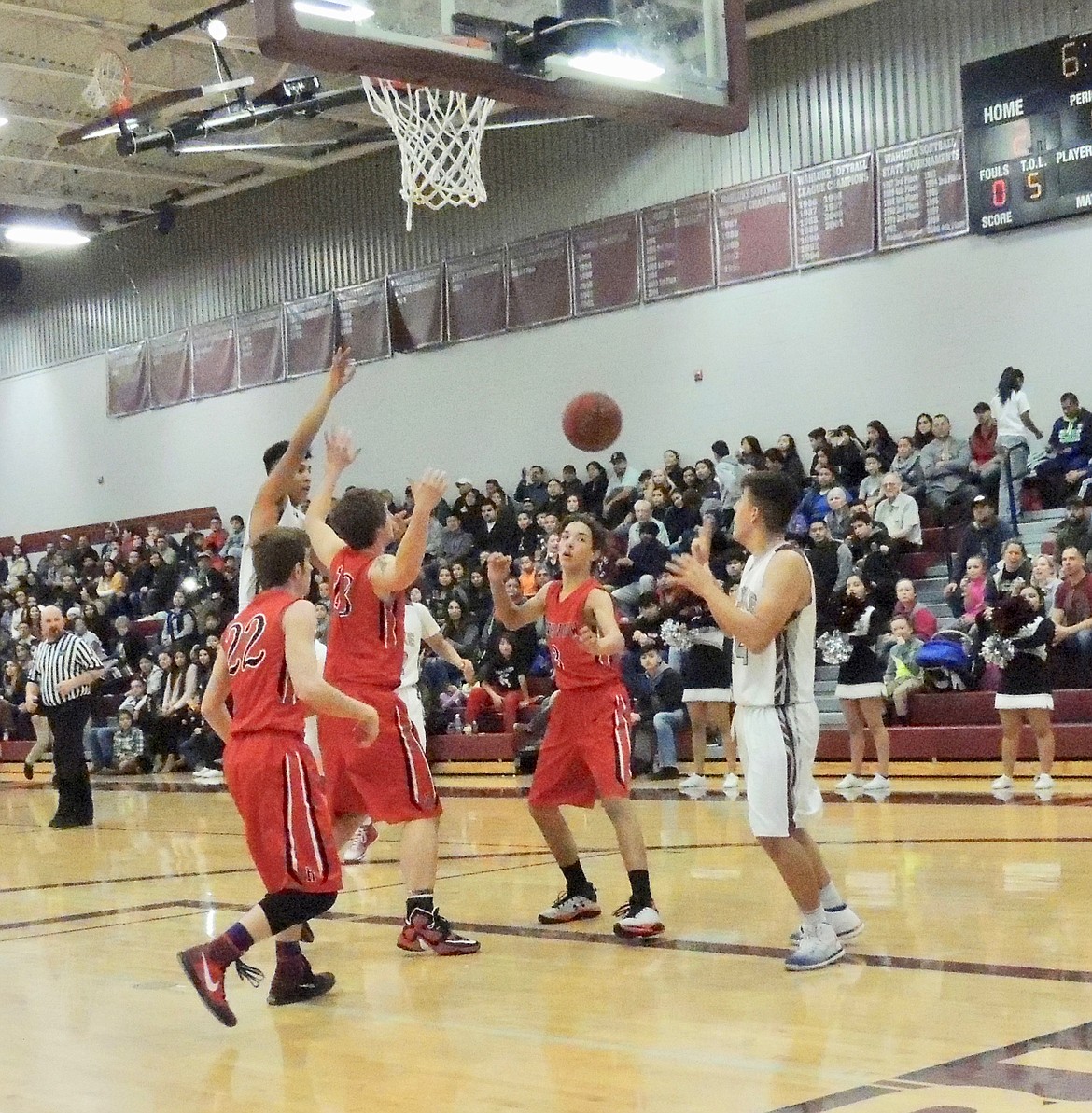 Ted Escobar/The Sun Tribune - Ricky Cabrera, one of the SCAC East&#146;s leading scorers, demonstrates why Wahluke has become a class 1A power in basketball. Driving to the basket he dishes off to wide open Alex Valdez.