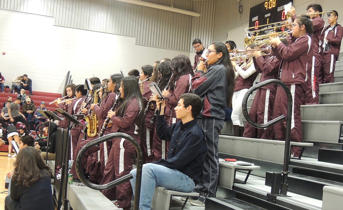 Ted Escobar/The Sun Tribune - The sometimes raucous Wahluke pep band, led by recent Royal graduate Jose Gonzalez, gets a close-up view of the team&#146;s first half offense, stationed behind the basket at which the Warriors start the game.