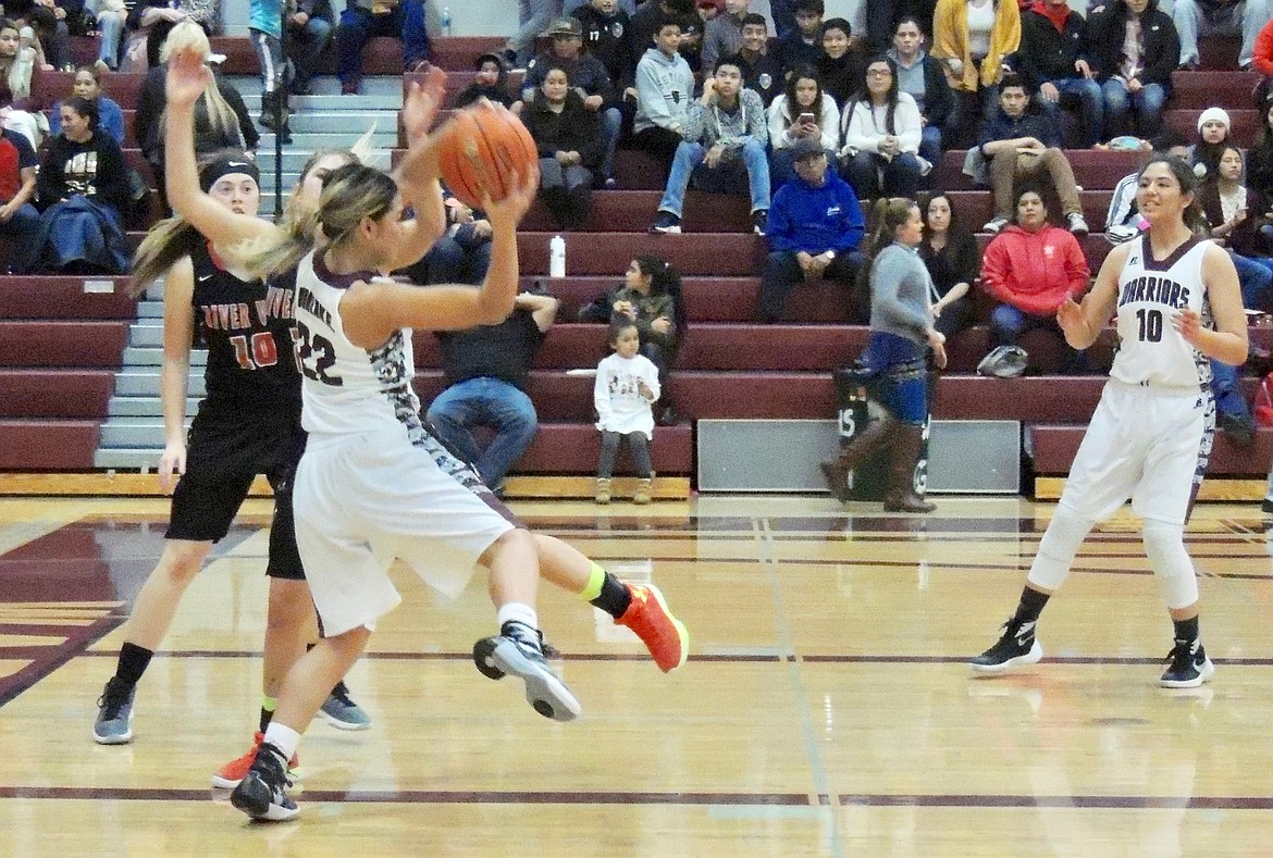 Ted Escobar/The Sun Tribune - Jacky Barajas of Wahluke grabs a rebound and looks toward Gissell Torres, 10, to make a pass.