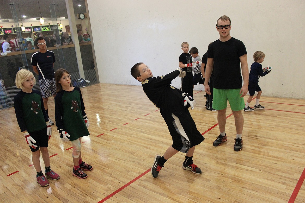 In this Press file photo taken Oct. 3, 2015, Brandon Freeman, 12, of Coeur d&#146;Alene, gets some tips from professional Irish handball player Stephen Cooney while Hana Luttman, 8, of Post Falls, left, and Hazel Plummer, 7, of Boise, watch him smack the ball during a kids handball clinic at Peak Health and Wellness Center.  - Photo courtesy of David Fink