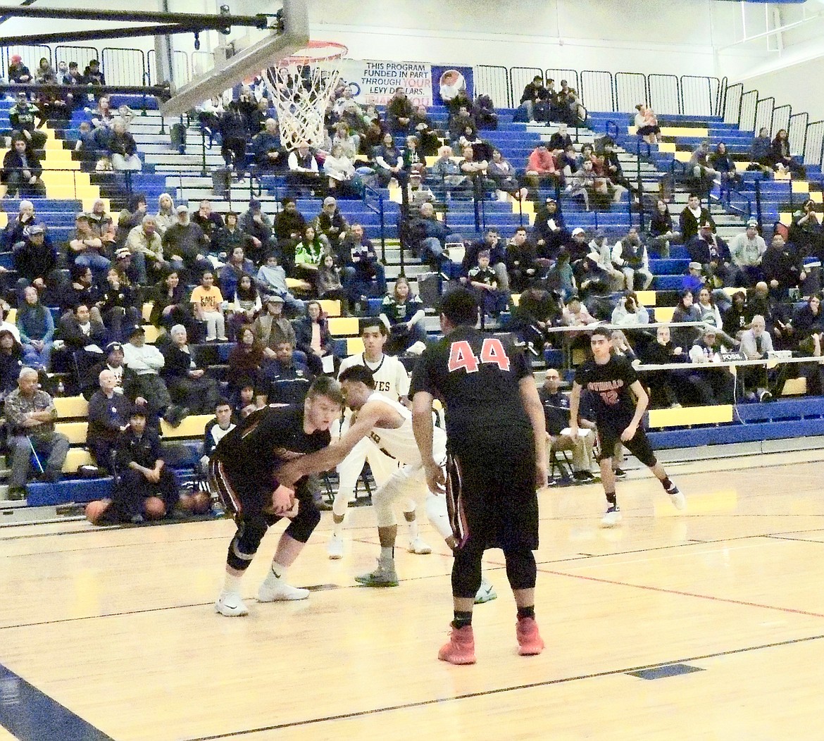 Ted Escobar/The Sun Tribune - Just before scoring two points with a lay-in, Trenton Cutforth of Othello wrestlers the ball away from a Wapato defender.