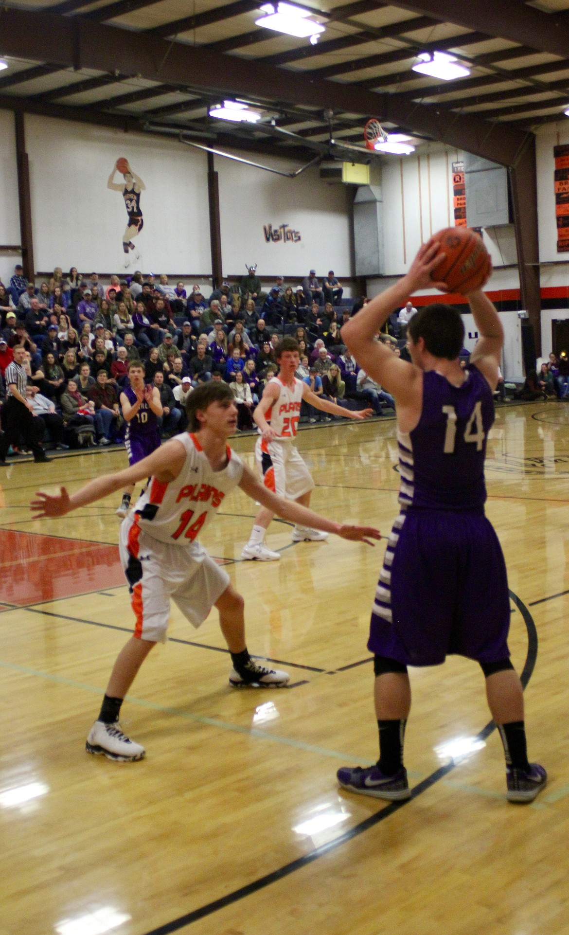 Charlo Vikings Landers Smith (14) is closely watched and guarded by Plains Horseman Kyle Weeks (14), as Charlo Vikings player Garrett Vaughan (10) and Horseman Tanner Ovitt (20) stand ready.