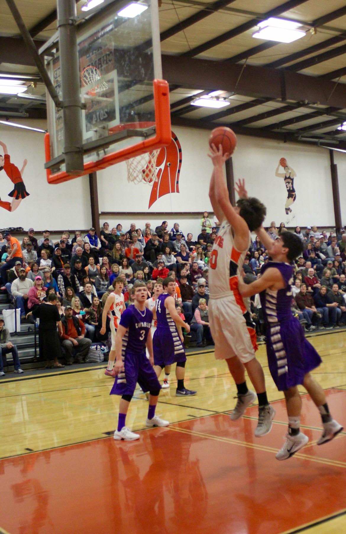 Plains&#146; Jay VonHeeder (40) goes up for a shot as Charlo players Zane Hafliger (30) and Tyson Pettigrew (3) try to defend.