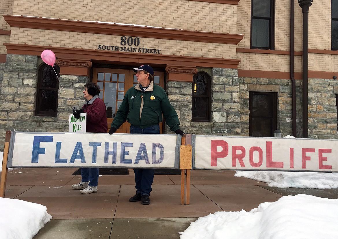 Ron and Juanita Rash hold signs at the Pro-Life Rally and March for Life in Kalispell on Saturday. (Matt Baldwin/Daily Inter Lake)