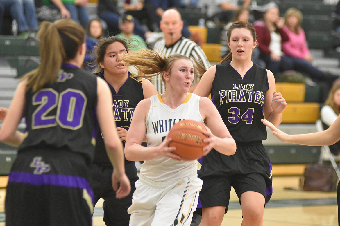 Lady Bulldog Annisa Brown, surrounded by Polson defenders, looks to make a pass during Saturday&#146;s game at Whitefish High School. (Heidi Desch/Whitefish Pilot)