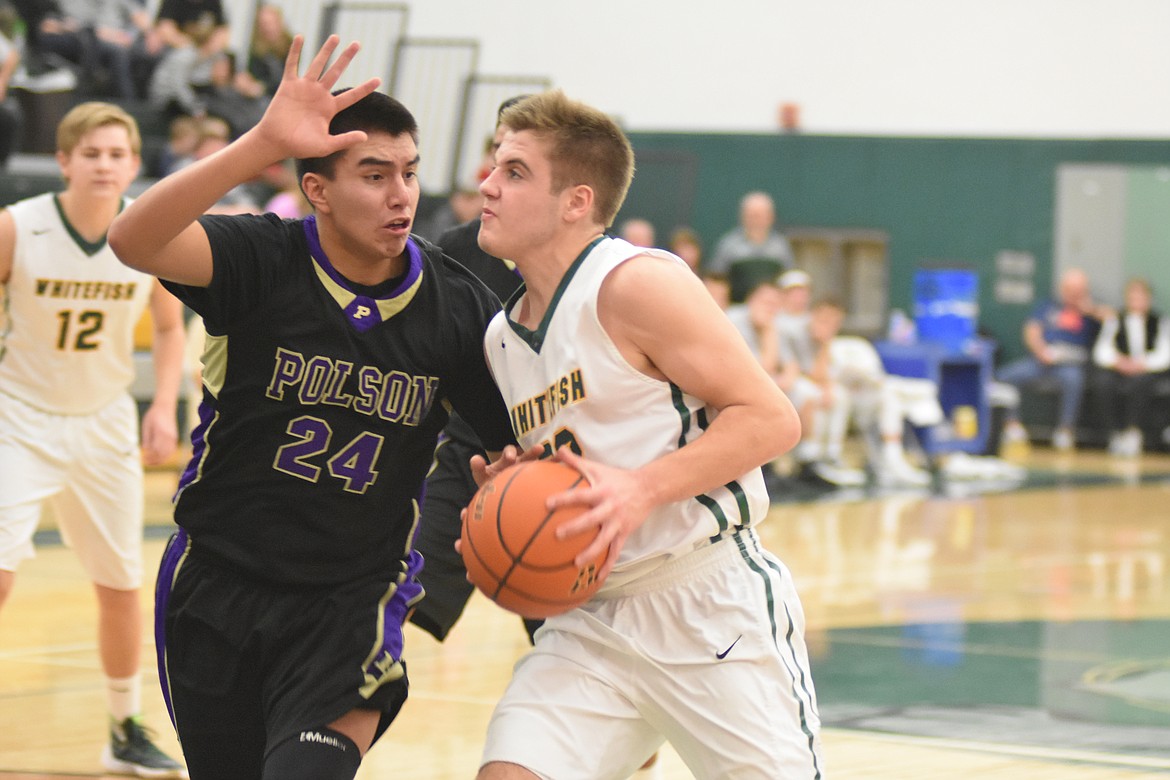 Bulldog Ryan Kemm drives to the hoop against Polson Saturday at the Whitefish High School gym. (Heidi Desch/Whitefish Pilot)