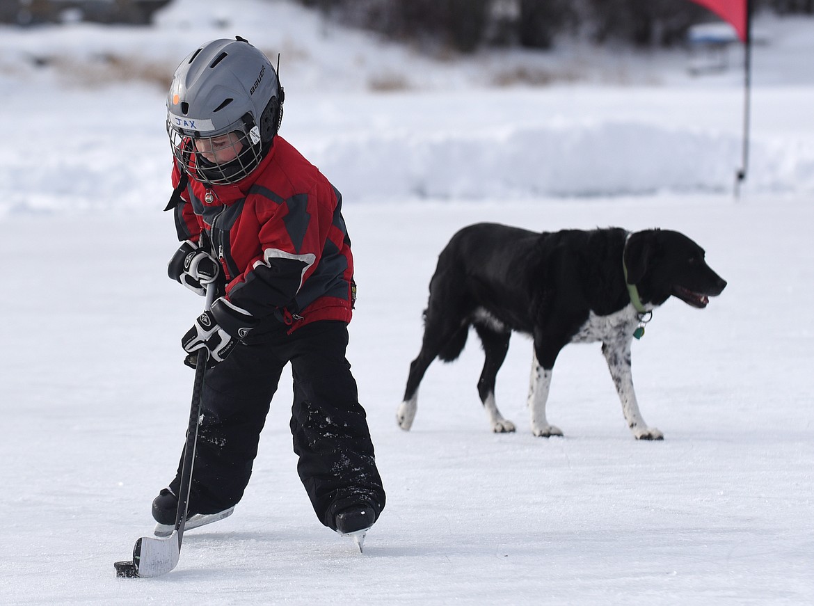 Jax Therien of Bozeman plays on the sidelines during the Montana Pond Hockey Classic at Foys Lake on Friday. (Aaric Bryan/Daily Inter Lake)