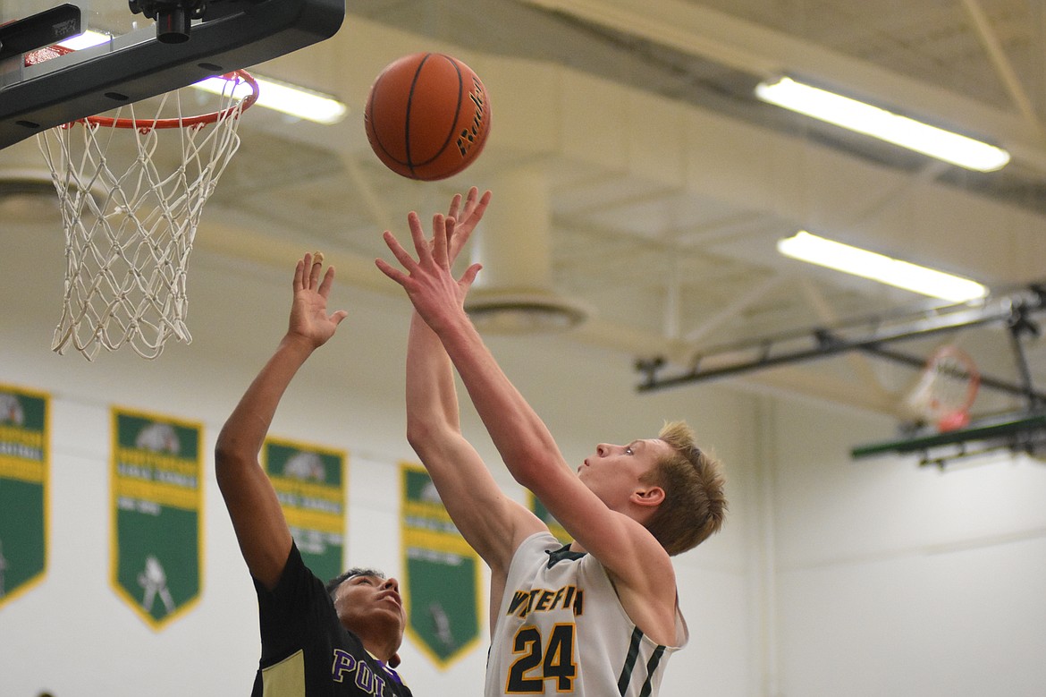 Bulldog Sawyer Silliker goes up for a shot over Polson Saturday at the Whitefish High School gym. (Heidi Desch/Whitefish Pilot)