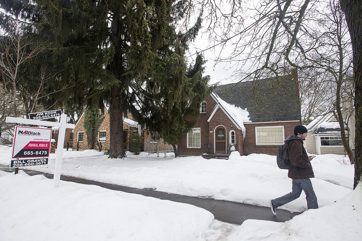 LISA JAMES/ PressA for sale sign sits outside a house for sale on Sherman Avenue and 11th Street in downtown Coeur D'Alene on Thursday. Home sales reached a 10-year high in 2016 in  Kootenai County. As prices rise, inventory continues to be lower than demand.