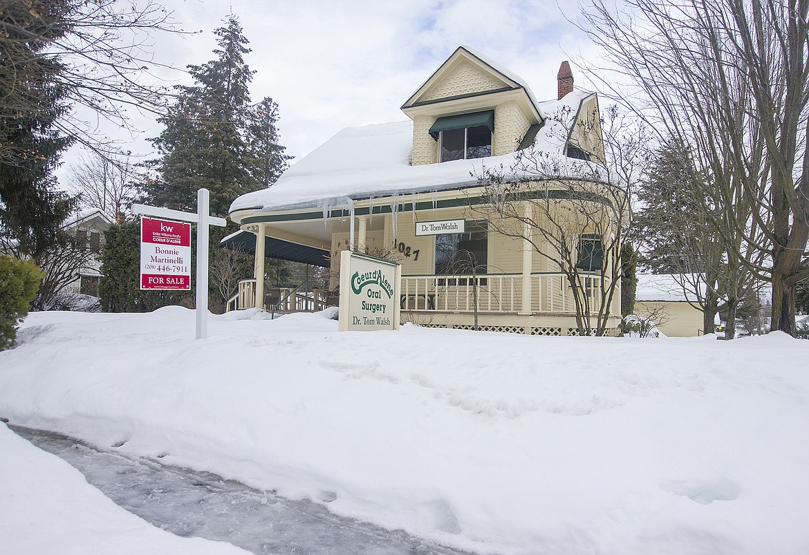 LISA JAMES/ PressA for sale sign sits outside a combination home/office for sale on Sherman Avenue and 11th Street in downtown Coeur D'Alene on Thursday. Home sales reached a 10-year high in 2016 in  Kootenai County. As prices rise, inventory continues to be lower than demand.