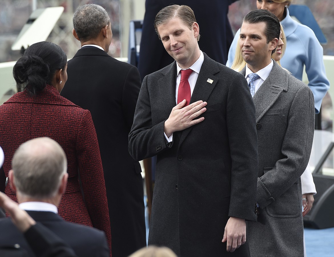 Eric Trump, center, and Donald Trump, Jr., attend the presidential inauguration of their father Donald Trump on Capitol Hill in Washington, Friday, Jan. 20, 2017. (Saul Loeb/Pool Photo via AP)