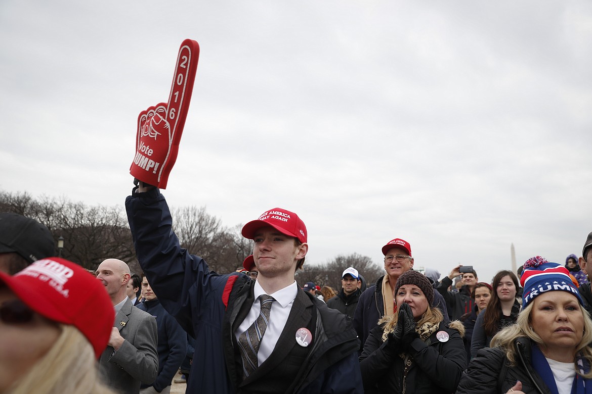 Supporters of Donald Trump gather on the National Mall during the inauguration of President-elect Donald Trump, Friday, Jan. 20, 2017, in Washington. (AP Photo/John Minchillo)