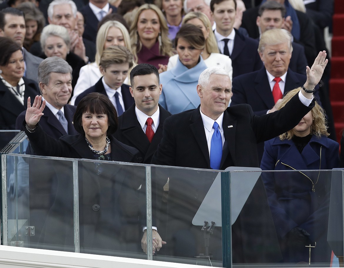 Vice President Mike Pence, flanked by his wife Karen, waves after being sworn in during the 58th Presidential Inauguration at the U.S. Capitol in Washington, Friday, Jan. 20, 2017.(AP Photo/Patrick Semansky)