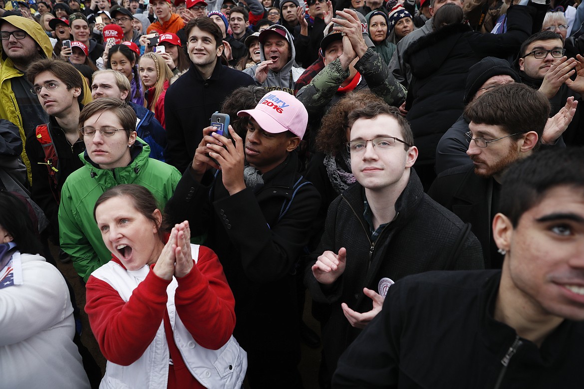 Spectators react to the arrival of President-elect Donald Trump during the inauguration of President-elect Donald Trump, Friday, Jan. 20, 2017, in Washington. (AP Photo/John Minchillo)