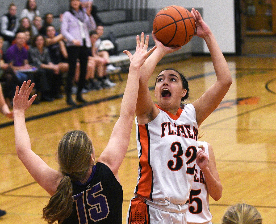 Flathead post Taylor Henley is fouled by Missoula Sentinel post Kylie Frohlich as she makes a basket during the third quarter at Flathead Tuesday. (Aaric Bryan/Daily Inter Lake)