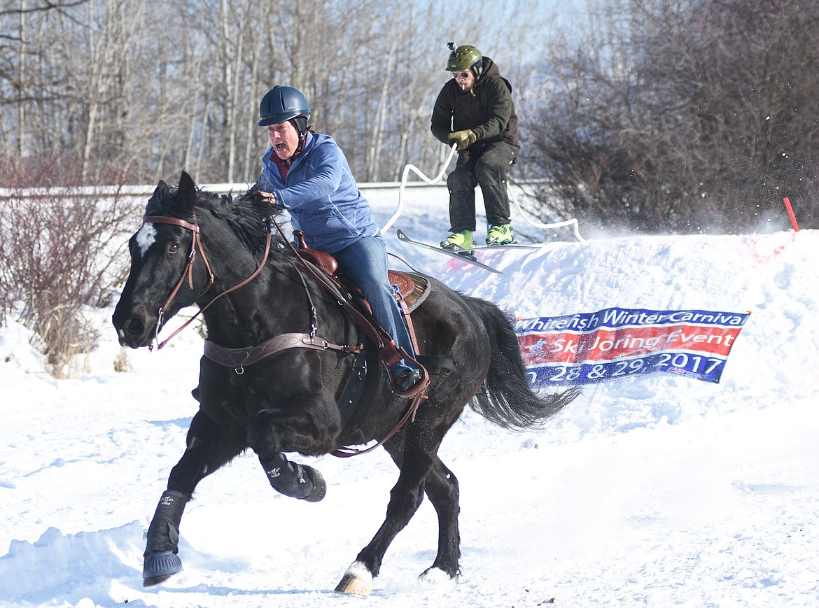 Cindy Thompson and Evan Kreps hit the final turn in the Novice race on Sunday.