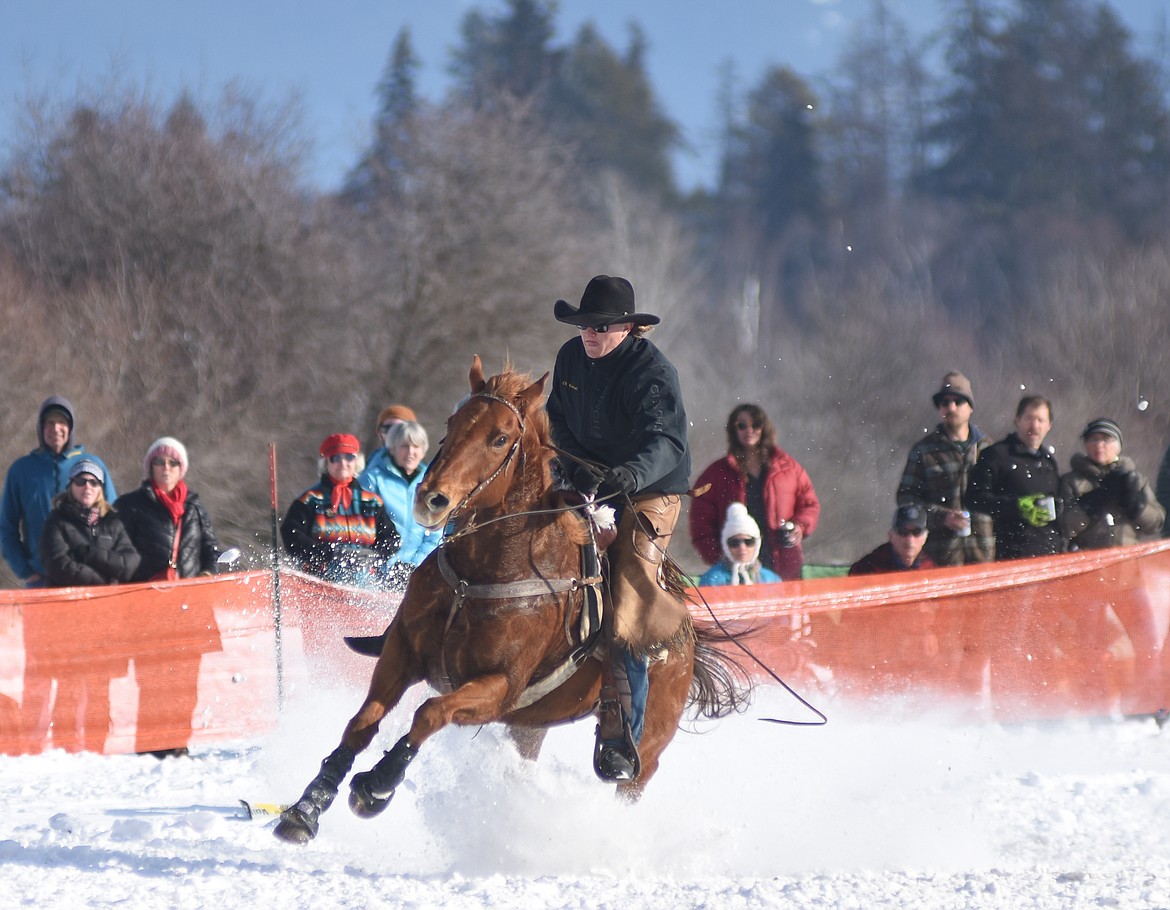 CR Kunesh turns the corner during the sport class of the skijoring race on Sunday.