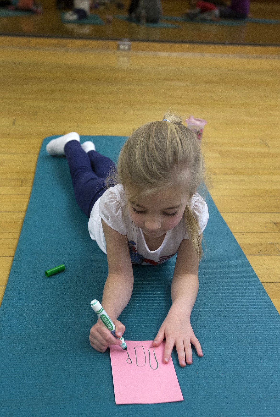 LISA JAMES/ Press
Haley Delaney, 5, draws a picture of the cross country skis she got for Christmas after kids were asked to draw something that makes them happy during Kim Polfer&#146;s Kids Yoga class at Peak Health &amp; Wellness Center on Wednesday morning.