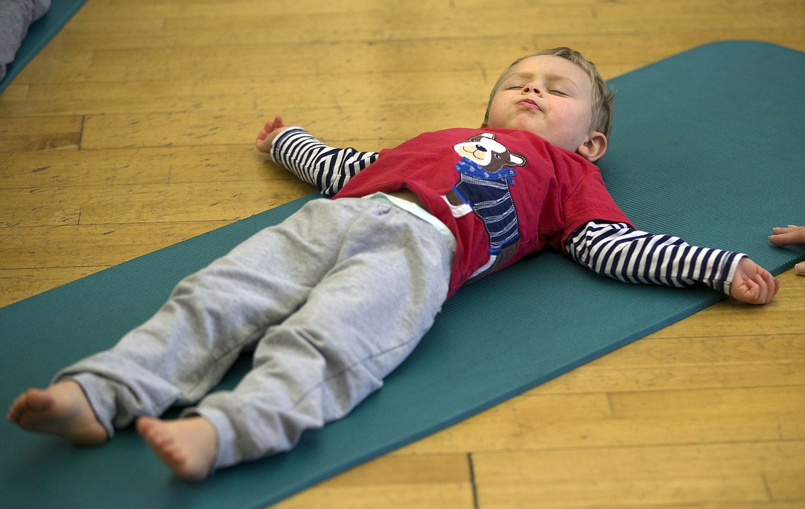 LISA JAMES/ Press
Conley Davison, 3, winds down at the close of Kim Polfer&#146;s Kids Yoga class at Peak Health &amp; Wellness Center on Wednesday morning.