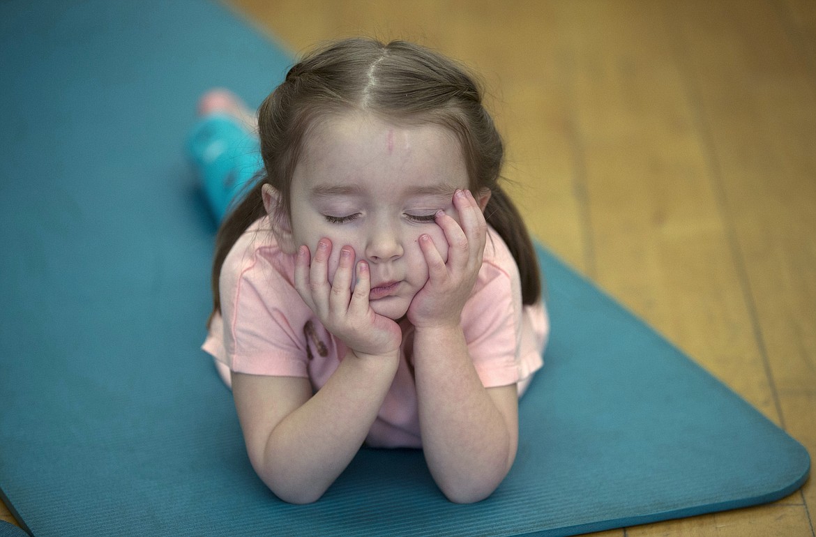 LISA JAMES/ Press
Fiona Kramer, 4, closes her eyes and visualizes during Kim Polfer&#146;s Kids Yoga class at Peak Health &amp; Wellness Center on Wednesday morning.