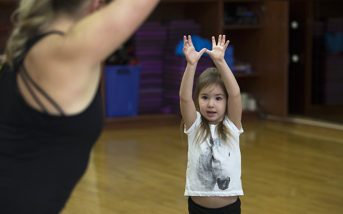 LISA JAMES/ Press
Kaylee Smith, 4, follows along during Kim Polfer&#146;s Kids Yoga class at Peak Health &amp; Wellness Center on Wednesday morning.