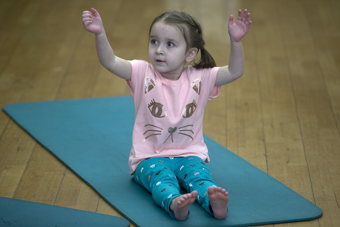 Fiona Kramer, 4, follows along during Kim Polfer&#146;s Kids Yoga class at Peak Health &amp; Wellness Center on Wednesday morning.

LISA JAMES/ Press