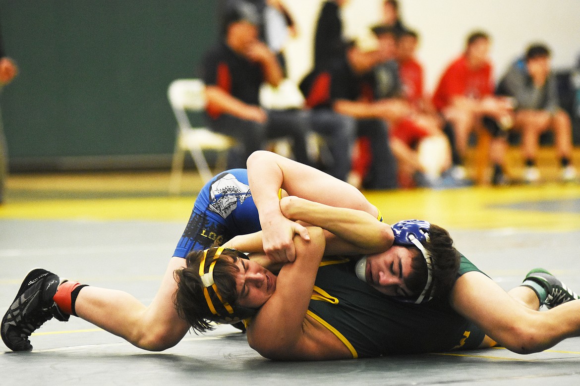 Whitefish's Eli Taylor fights off Libby's Trey Thompson during the Whitefish Duals on Friday.