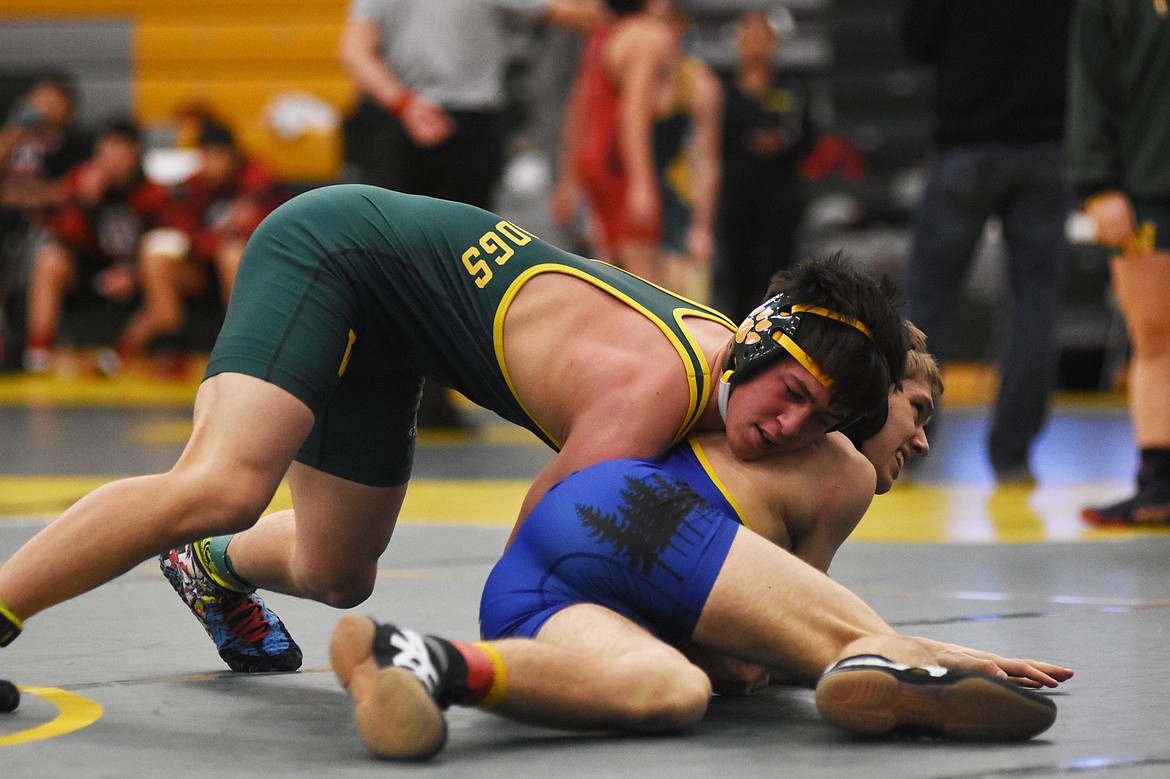 Dakota Flannery grapples with Libby's Reed Christensen during the Whitefish Duals on Friday.