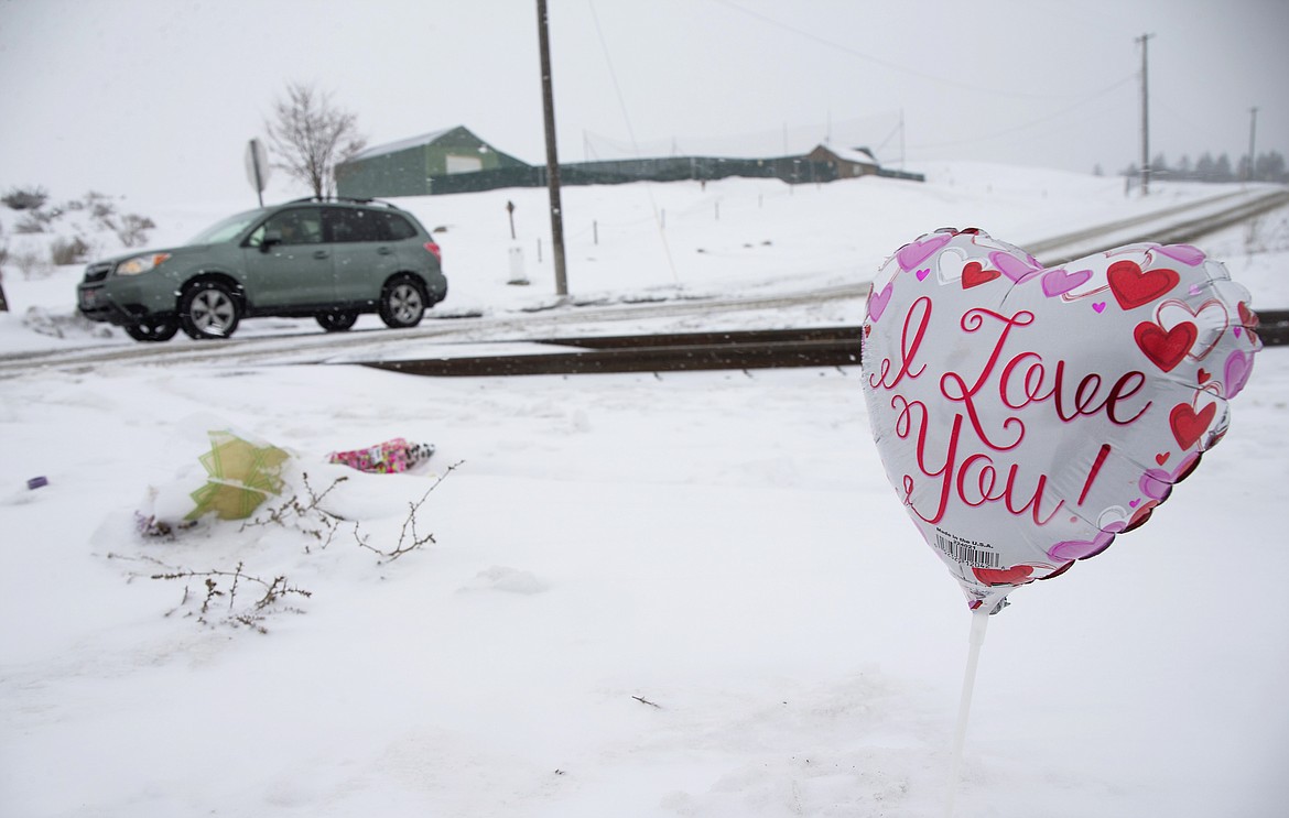 LISA JAMES/ Press
Flowers and balloons are being left where a fatal accident occurred when a train hit a car crossing the tracks at Spokane Street near Prairie Avenue in Post Falls early Tuesday morning. The passenger, Mikelli Villase&ntilde;or, 15, was killed in the collision and Jacob Brockus, 17, the driver of the vehicle, is in fair condition at Kootenai Health.