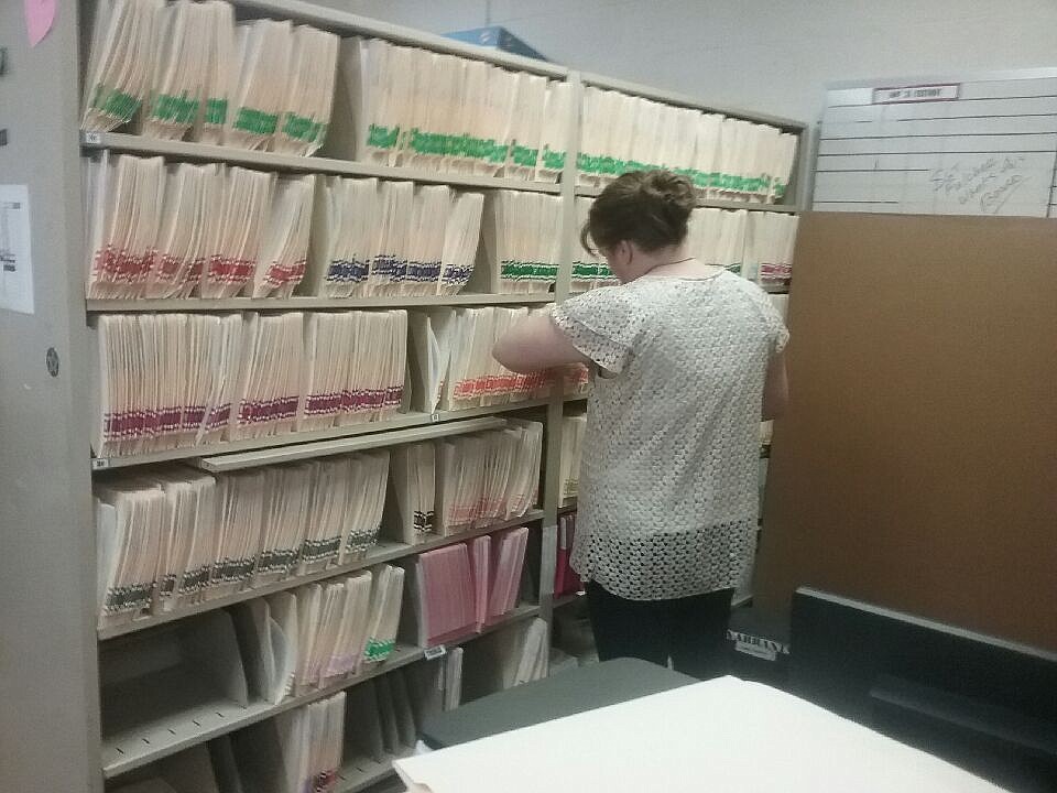 Photo/Ryan Collingwood

Extraditions coordinator Stephanie Jacobs looks through old warrants Friday at the Kootenai County Jail.