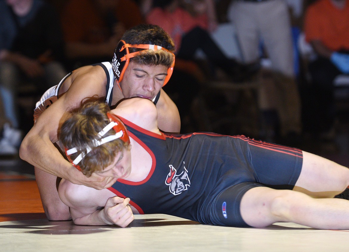 Flathead 132-pound Trae Vasquez gets a hold of Missoula Hellgate's Nate Brown during a dual in January. (Aaric Bryan/Daily Inter Lake)