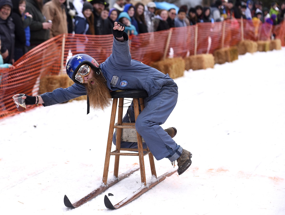 CARY KOSLTAD celebrates as he crosses the finish line during the Cabin Fever Days barstool races in Martin City in 2016. (Aaric Bryan/This Week in the Flathead)