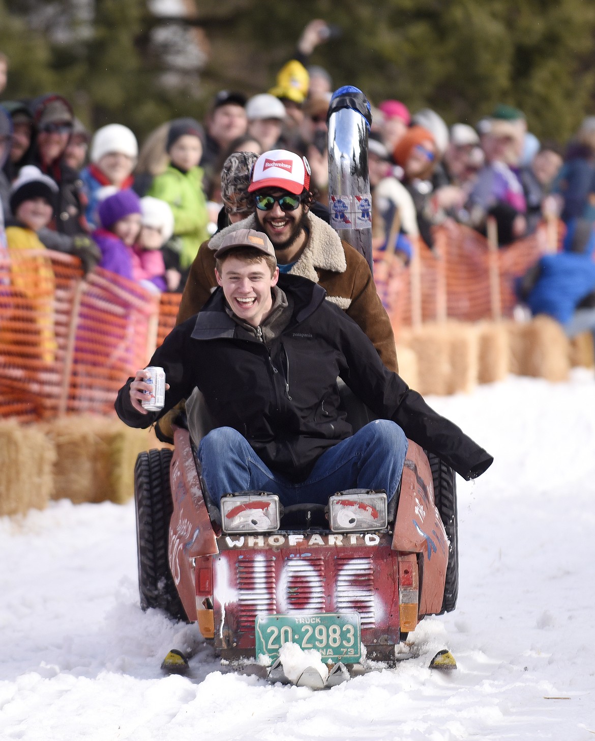 TEAMMATES SLIDE toward the finish line during the barstool races at Cabin Fever Days in Martin City in 2016. (Aaric Bryan/This Week in the Flathead)