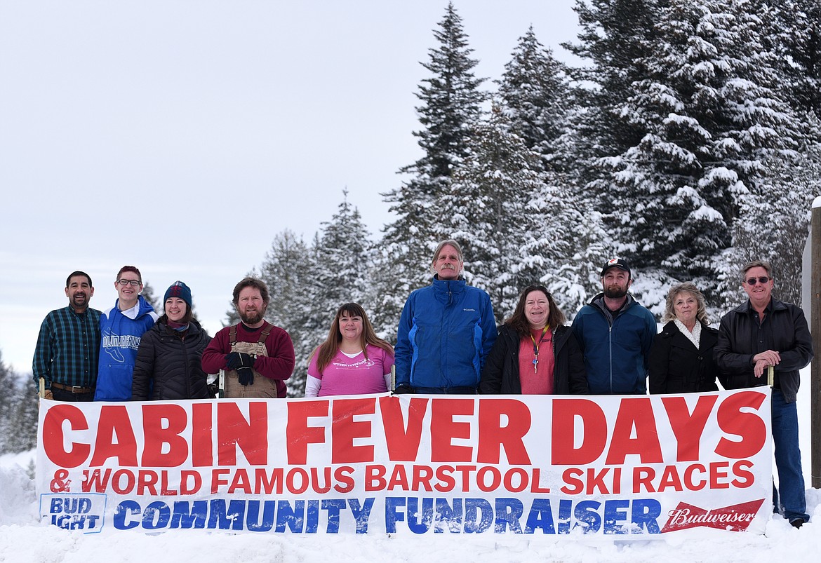 CABIN FEVER days volunteer organizers, from left, Dave Ruis, Landon Ruis, Stacey Schnebel, Chad Bruns, Kelly Weigant, Greg Vorhees Lori Kaml, Ben Shafer, Nonie Pruett and Monty Pruett pose for a photo in Martin City on Feb. 7, 2017. (Aaric Bryan/This Week in the Flathead)