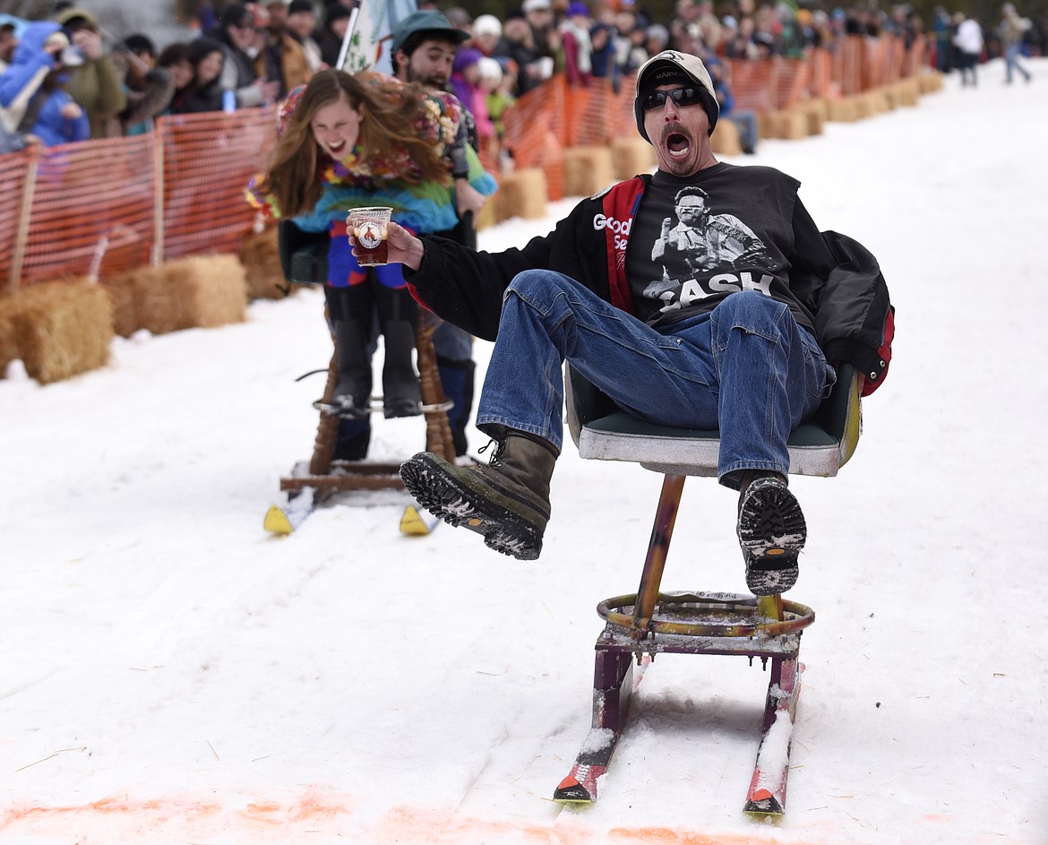 GARY WALLETTE yells as he crosses the finish line ahead of Jamie Dawson and Tyler McRae during the Cabin Fever Days barstool races in Martin City in 2016. (Aaric Bryan/This Week in the Flathead)