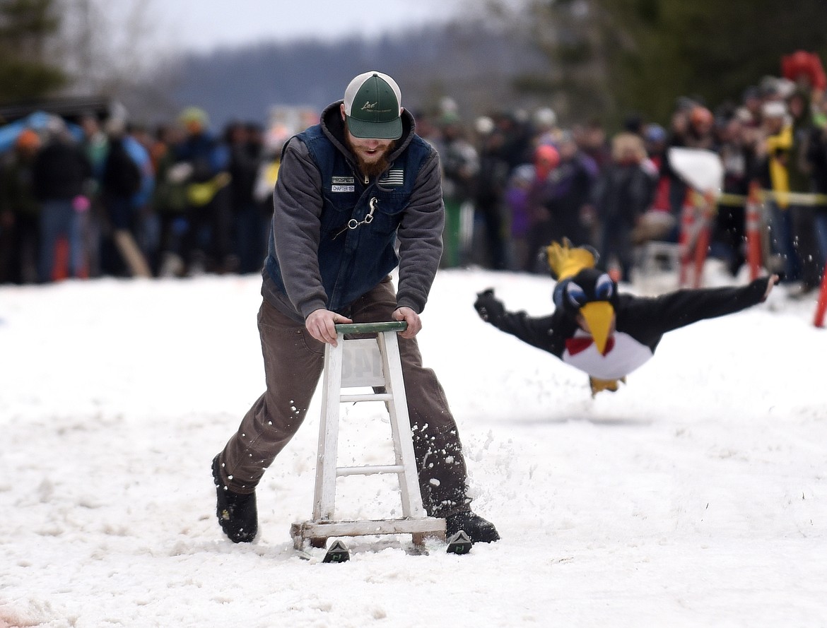 AN AIRBORN penguin follows a barstool down the hill during Cabin Fever Days in 2016. (Aaric Bryan/This Week in the Flathead)