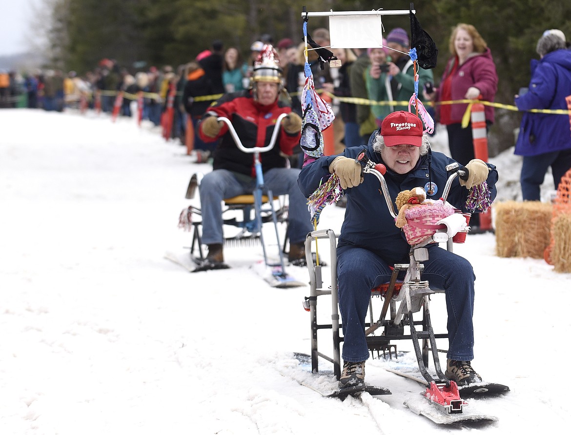 COMPETITORS SLIDE down the hill during barstool races at the 2016 Cabin Fever Days in Martin City. (Aaric Bryan/This Week in the Flathead)